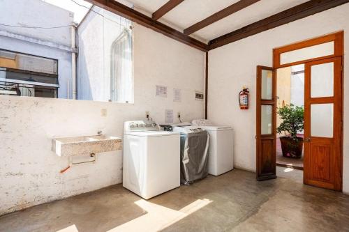 a laundry room with two washing machines and a sink at Amazing loft w/ terrace in Mexico City Downtown in Mexico City
