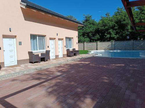 a patio with a table and chairs next to a pool at Navigator in Palić
