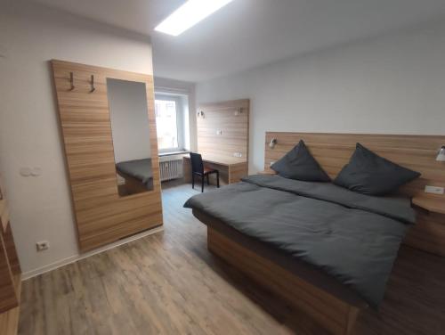 a bedroom with a bed and a desk and a mirror at City Apartments Essen in Essen