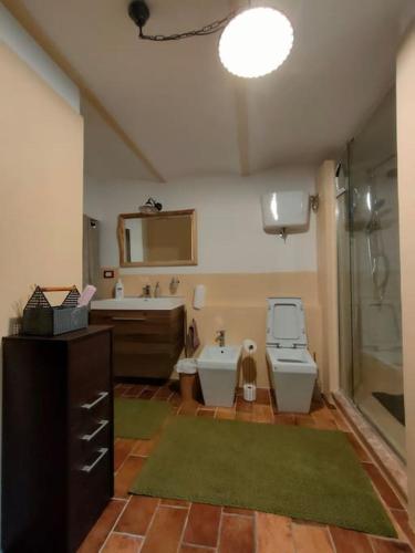 a bathroom with a shower and a sink and a toilet at La Casa di Agnese in Spello