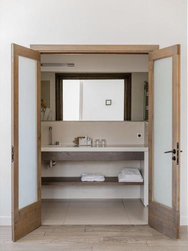 a bathroom with a sink and a mirror at Aethos Corsica in Oletta