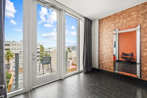 a balcony with sliding doors and a view of the city at The Fairwind Hotel in Miami Beach