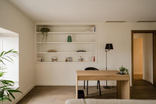 a living room with a table and shelves at Aethos Corsica in Oletta