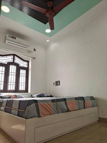 a bedroom with a bed in a room with a ceiling at Treva Pent House in Thirunallar