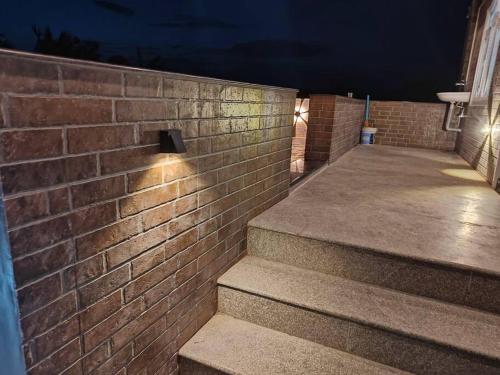 a brick wall with stairs in front of a building at Treva Pent House in Thirunallar