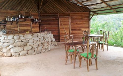 a patio with a table and chairs in a cabin at Tierra Madre Eco Lodge in Los Andes
