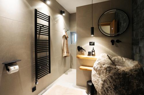 La salle de bains est pourvue d'un lavabo et d'un miroir. dans l'établissement Alpine Cottage Golica, à Jesenice
