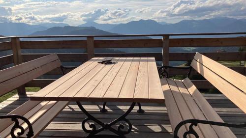 a wooden picnic table sitting on top of a deck at Almhütte Andrea in Wildschönau