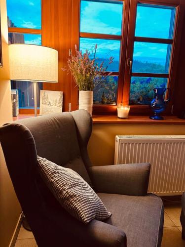 a living room with a couch and a window at Hotel Oddech in Pec pod Sněžkou