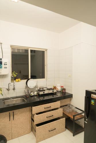 a kitchen with a sink and a counter top at Boho - By Great Impressions in Pune