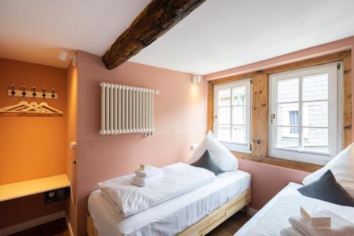 a bedroom with two beds and a window at Boutique-Hotel Stadtherberge Wetzlar in Wetzlar