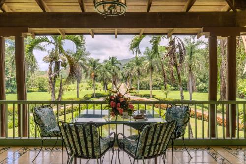a dining room with a table and chairs on a balcony at Hotel Casa Turire in Turrialba