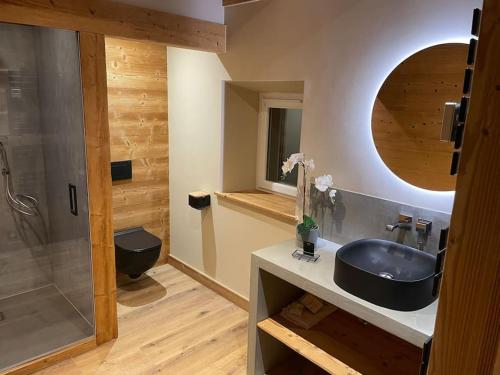 a bathroom with a black sink and a shower at GITE La fromagerie Haut Jura in La Mouille