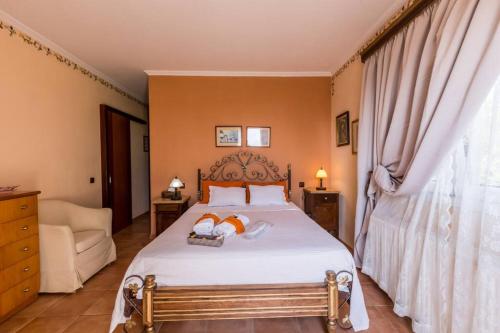 a bedroom with a bed with two towels on it at Aerino House in Dassia
