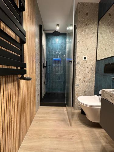 a bathroom with a shower and a toilet and a sink at MISVEST Tomasz Klimatyzacja in Zabrze