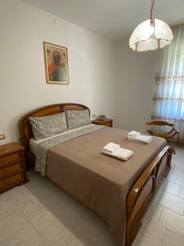 a bedroom with a bed with two towels on it at Le allodole in Bellano