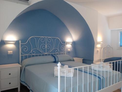 a bedroom with a bed with a blue ceiling at Antico Palazzo Spinola in Gallipoli