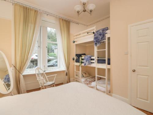 a bedroom with a bed and a window at Silverbells in Millport