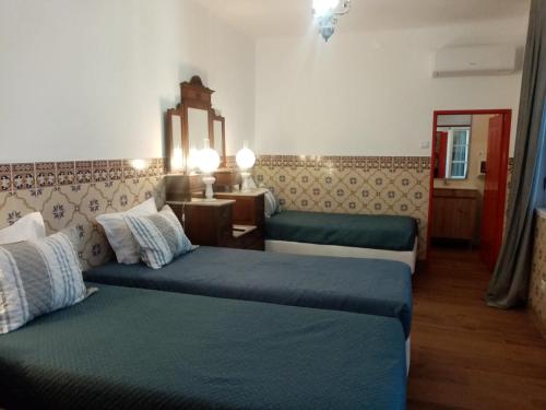 a hotel room with two beds in a room at Alentejo Cante & Vinho in Ferreira do Alentejo