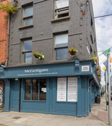 a building with a blue storefront on a street at McGettigan's Townhouse - Olives & Figs Bistro in Dublin