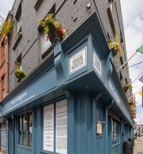 a blue building with flowers on the front at McGettigan's Townhouse - Olives & Figs Bistro in Dublin