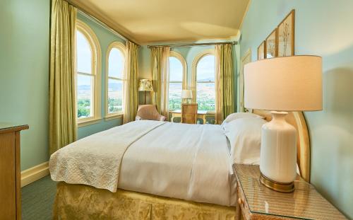 a bedroom with a bed and a table with a lamp at Ashland Springs Hotel in Ashland