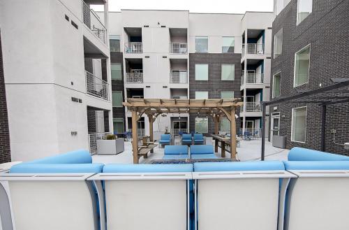 a view of a patio with blue chairs in a building at Kasa Downtown Salt Lake City in Salt Lake City