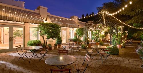 an outdoor patio with tables and chairs and lights at Ashland Springs Hotel in Ashland