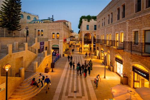 a group of people walking down a street at Lily Studio Apart *Top location* in Jerusalem