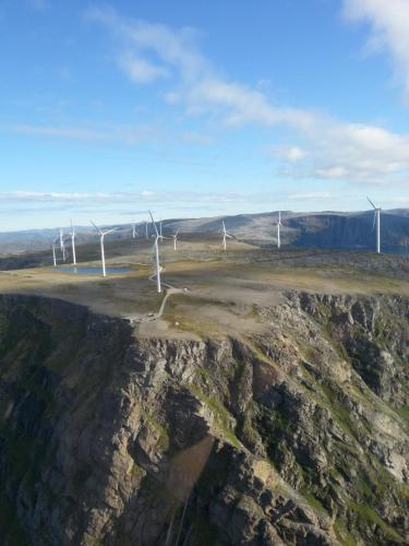 an aerial view of a group of wind turbines on a mountain at Apartament 2 in Havøysund
