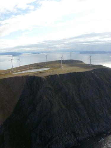an aerial view of a wind farm on top of a mountain at Apartament 1 Havoysund in Havøysund