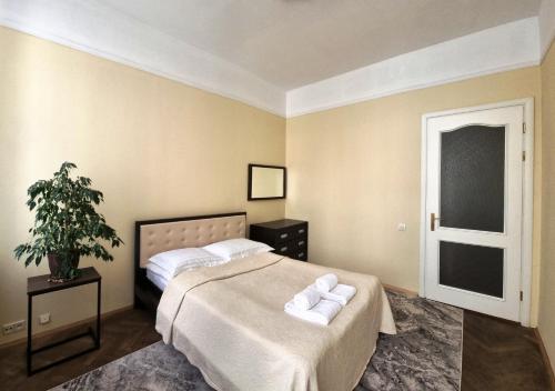 a bedroom with a bed with two towels on it at Cozy Apartment in Lviv