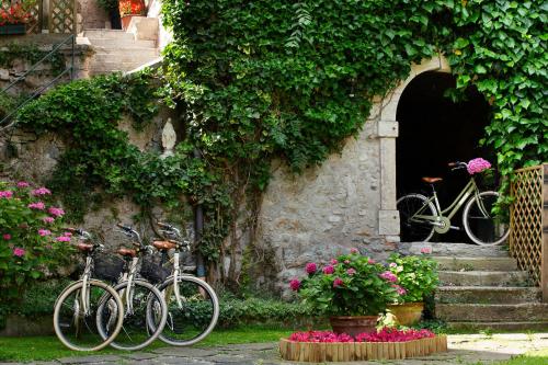two bikes parked in front of a building with flowers at Villa Angelica in Riva del Garda