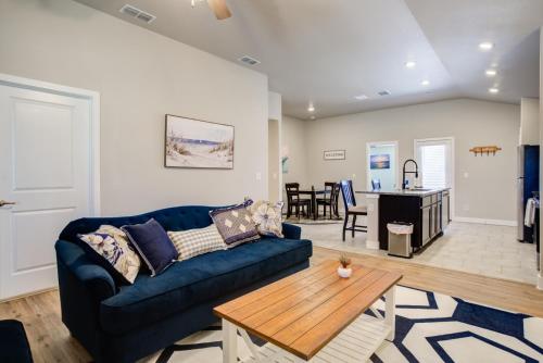 a living room with a blue couch and a table at Milano Lodge - Cozy Retreat in Lubbock