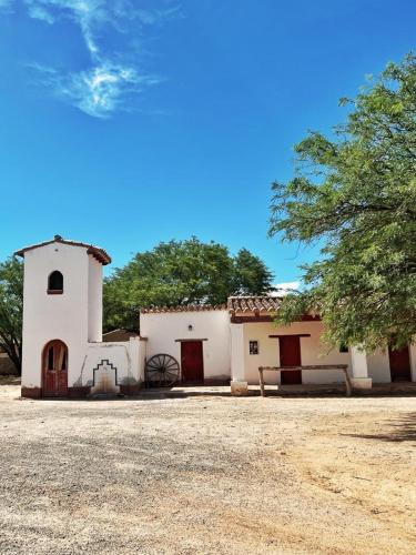 a small white building with a tree in front of it at La Vaca Tranquila in San Carlos