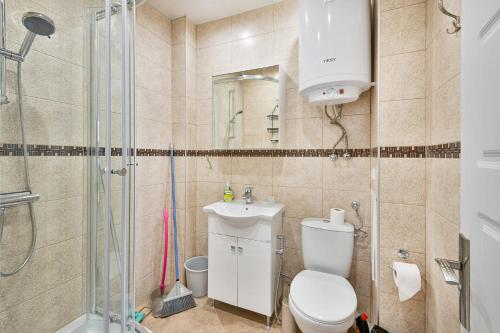 a bathroom with a shower and a toilet and a sink at Delta Planet budget flat 2 guests in Varna City