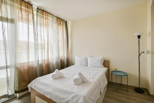 a bedroom with a large white bed with towels on it at Delta Planet budget flat 2 guests in Varna City