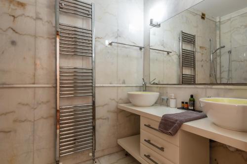 a bathroom with two sinks and a mirror at Angels Villa in Kambánion