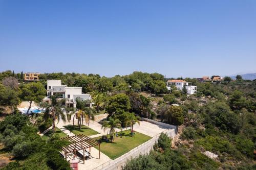 an aerial view of a resort with a pool and trees at Angels Villa in Kambánion