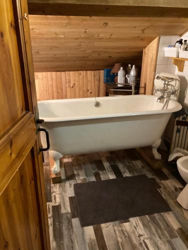 a bath tub in a bathroom with a wooden ceiling at Chalet 09 in Albiès