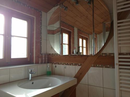 a bathroom with a sink and a mirror at NaturflairHaus in Königstein an der Elbe