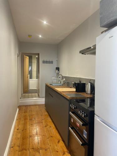 a kitchen with a sink and a stove top oven at Great 2 bedroom flat in Plymouth