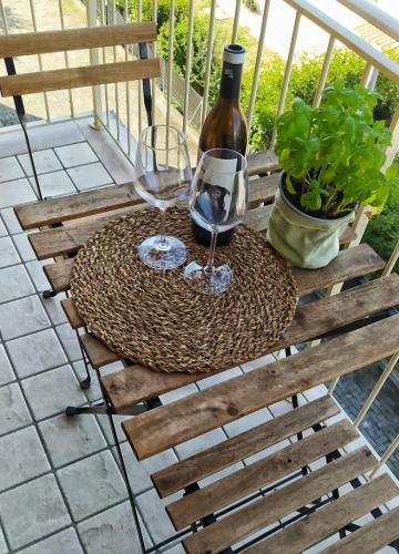a table with two glasses and a bottle of wine at La Casa di Alice in Bomporto