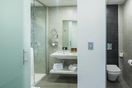 a bathroom with a shower and a sink and a toilet at Riu Plaza New York Times Square in New York