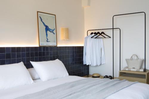 a bedroom with a bed and a blue tiled wall at Sirene Blue Luxury Beach Resort in Poros