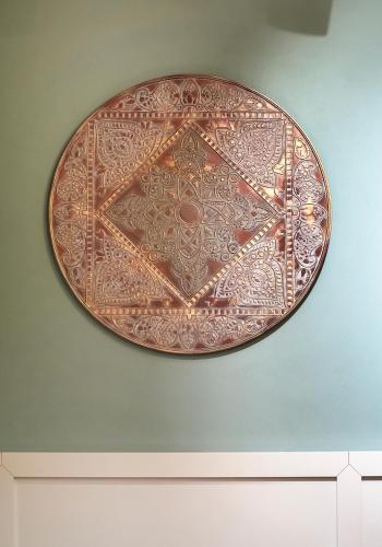 a plate is hanging on a wall at Apartamenty Sowa Toruń in Toruń