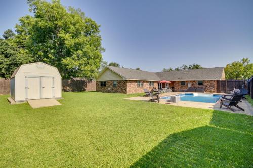 a backyard with a pool and a shed at Inviting Gulfport Home with Private Pool and Yard in Gulfport