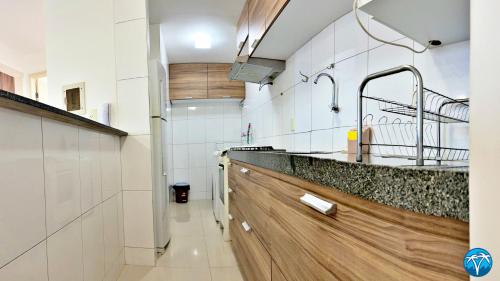 a kitchen with a sink and a faucet at Vacanze - Ametista 7 in Maceió