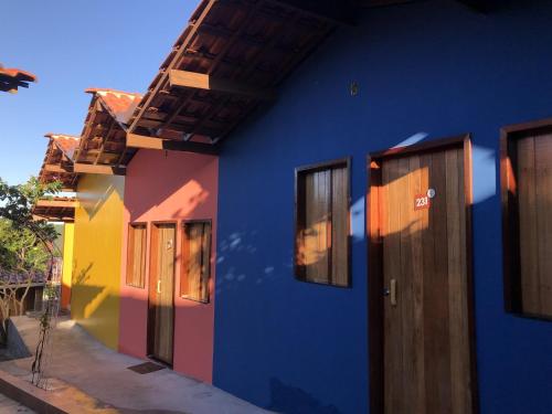 a blue building with colorful walls and windows at Pedra do Sino Hotel in Piranhas