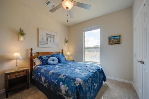 a bedroom with a blue bed and a window at Hill Country Casita with Patio 13 Mi to Dtwn Boerne in Kreutzberg